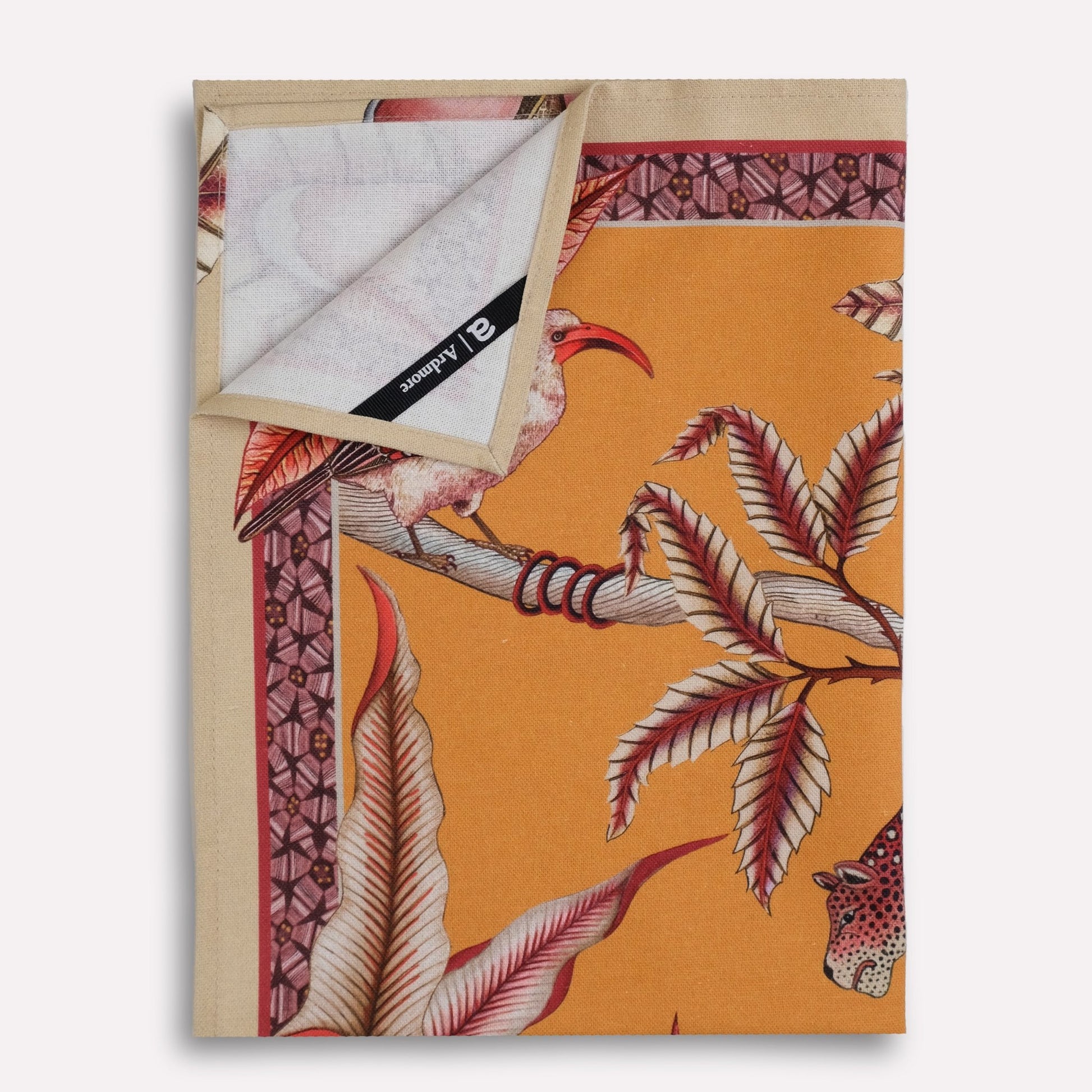 A neatly folded display showcasing the vibrant design, blending nature and wildlife in a luxurious fabric.