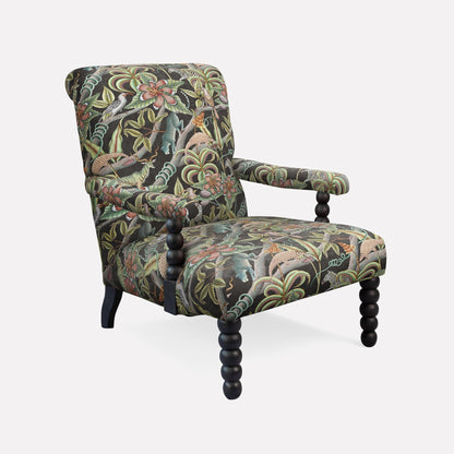 Ardmore Kudu Pod Chair in Pangolin Park Night Velvet, featuring a striking African-inspired botanical print, plush upholstery, and elegant black wooden legs.