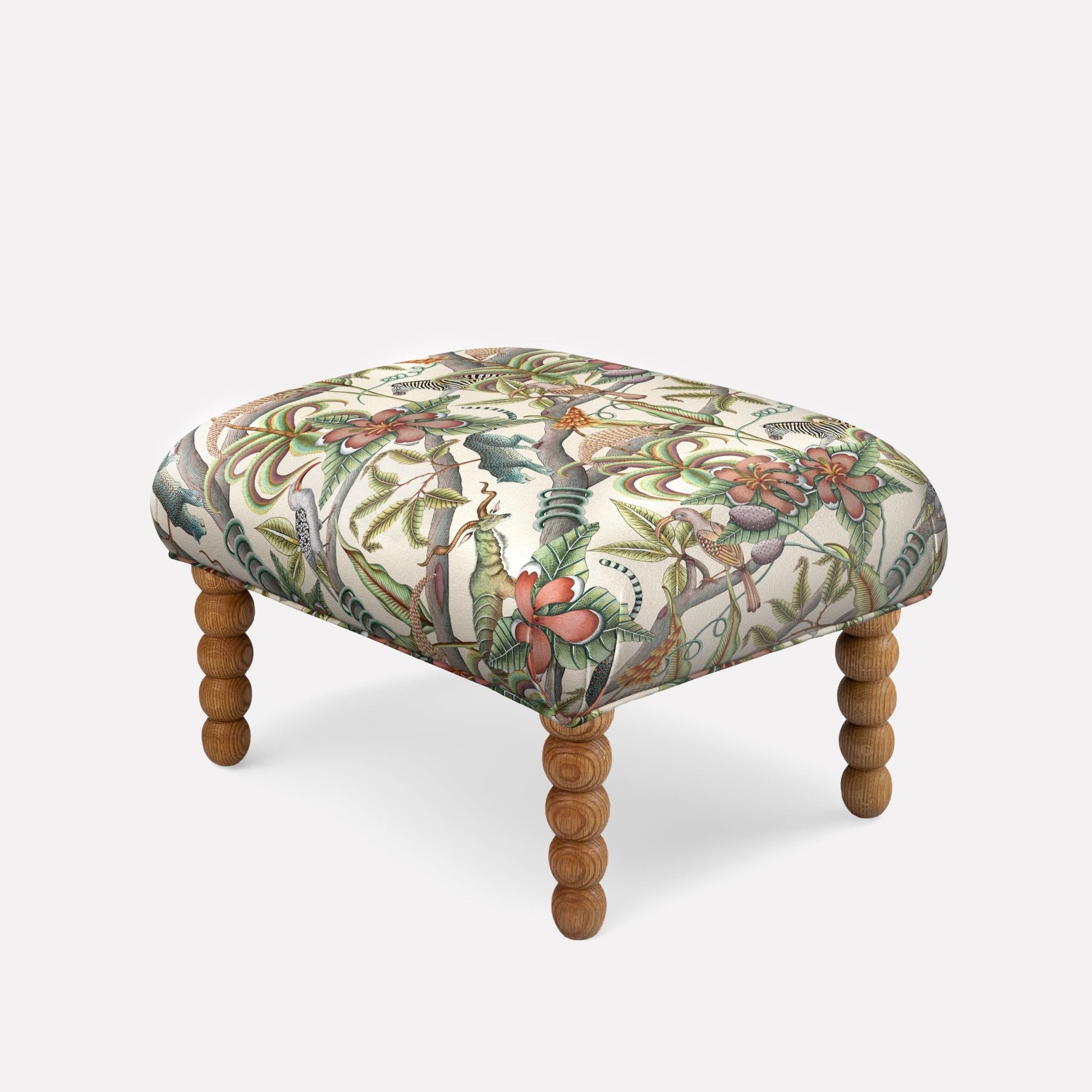 Ardmore Kudu Pod Ottoman in Pangolin Park Chalk Linen, featuring a nature-inspired print with turned wooden legs.