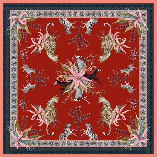 A striking square tablecloth in deep red, intricately decorated with sable, zebras, leopards, and lush floral elements, framed by an ornate border.