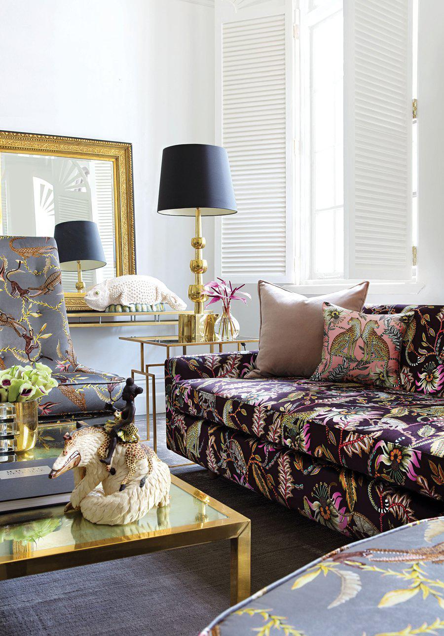 Styled image of the Lovebird Leopards Magnolia Silk Cushion Cover on a sofa in an elegant living room, blending luxury and comfort.