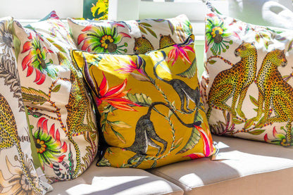 Display of multiple Lovebird Leopards Parakeet cushion covers arranged together, showcasing the vibrant patterns and colours.