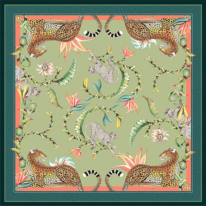 A square tablecloth with an intricate green design featuring leopards, monkeys, birds of paradise, and passion flowers, bordered by a decorative pattern.
