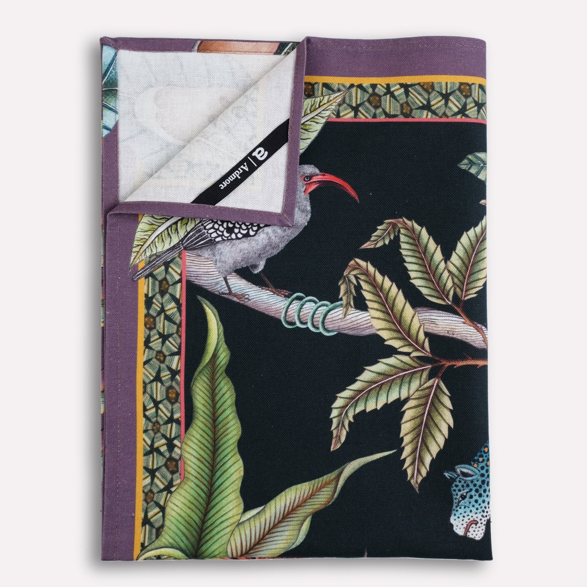 A neatly arranged stack of tea towels, revealing glimpses of the unique botanical and wildlife patterns.