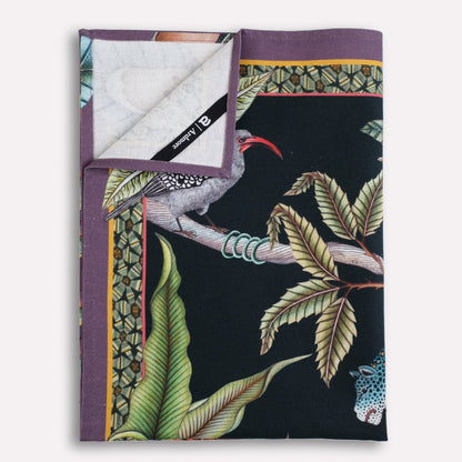 A neatly arranged stack of tea towels, revealing glimpses of the unique botanical and wildlife patterns.