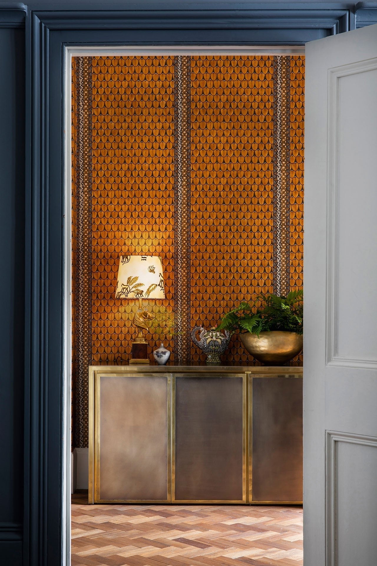 A luxurious setting featuring the Narina wallpaper as a sophisticated backdrop with deep blue undertones.