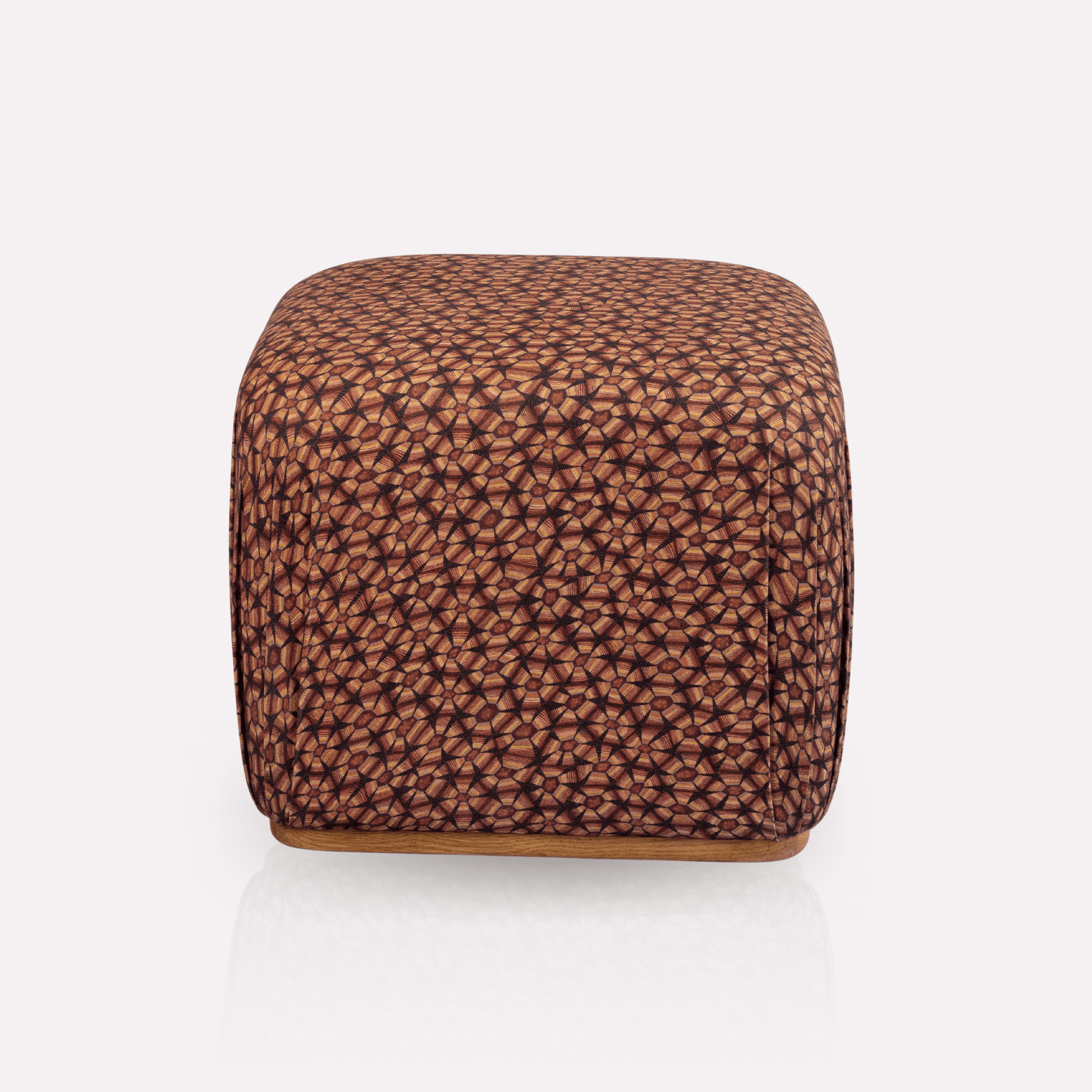 A luxurious Nyala Ottoman with a rich tortoise shell-inspired pattern in deep plum and earthy brown tones. The ottoman has a smooth, cube-like silhouette, offering a plush and sophisticated seating or decorative piece.