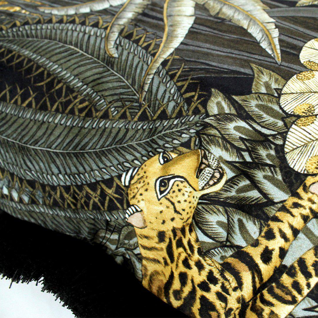 Zoomed-in detail of the Sabie Forest Moonlight cushion cover, highlighting a leopard resting among intricately designed foliage in shades of gold, green, and black.