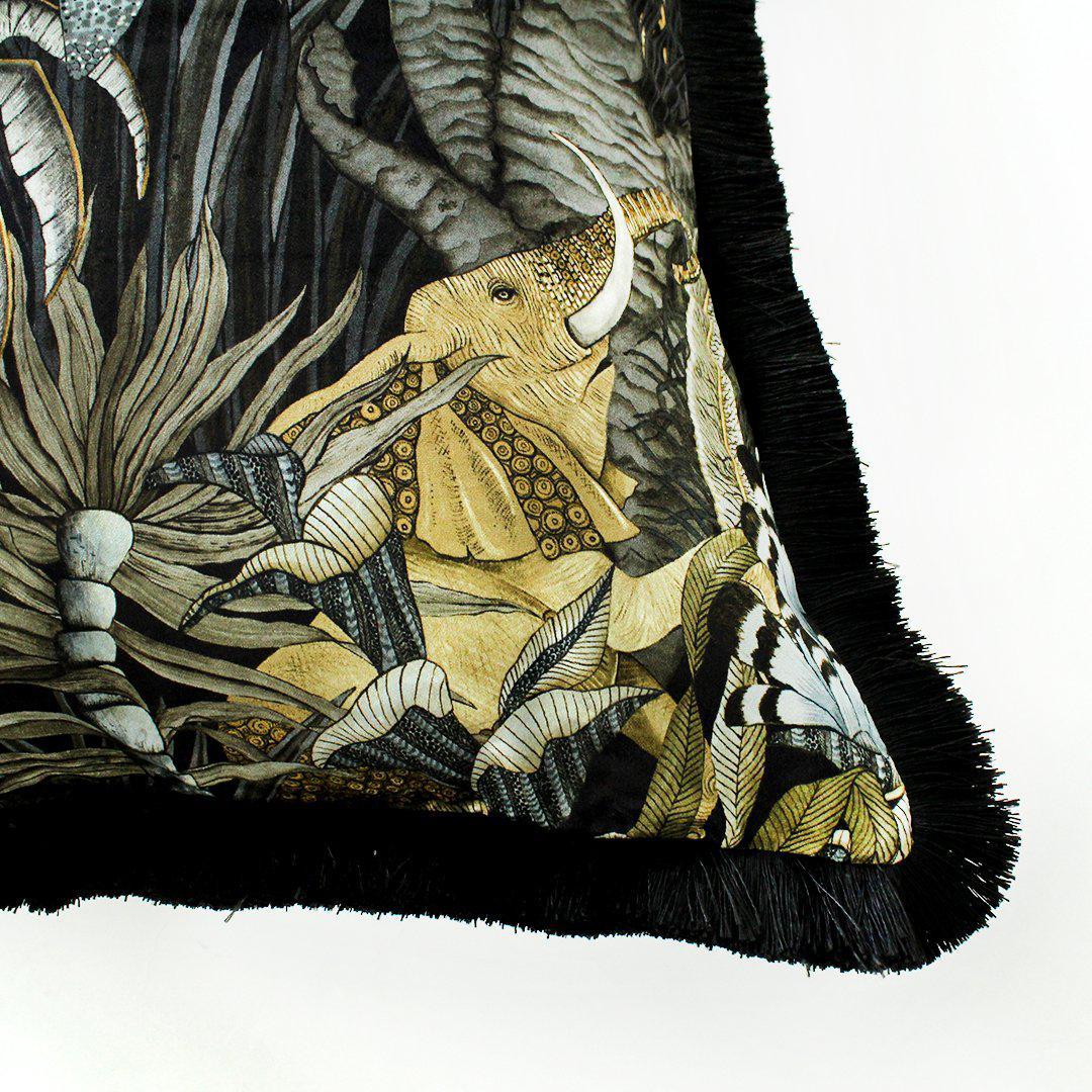 Side angle of the Sabie Forest Moonlight cushion cover, illustrating the luxurious black fringe edge and the continuation of the vibrant wildlife design along the cushion's borders.