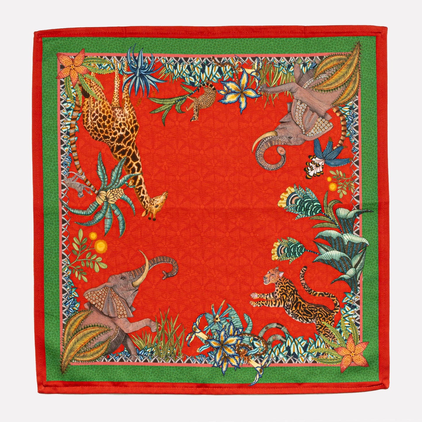 A full view of the Ardmore Sabie Forest Napkin in Royal Red, featuring a rich botanical design with tropical leaves, intricate floral elements, and a regal leopard at the center.