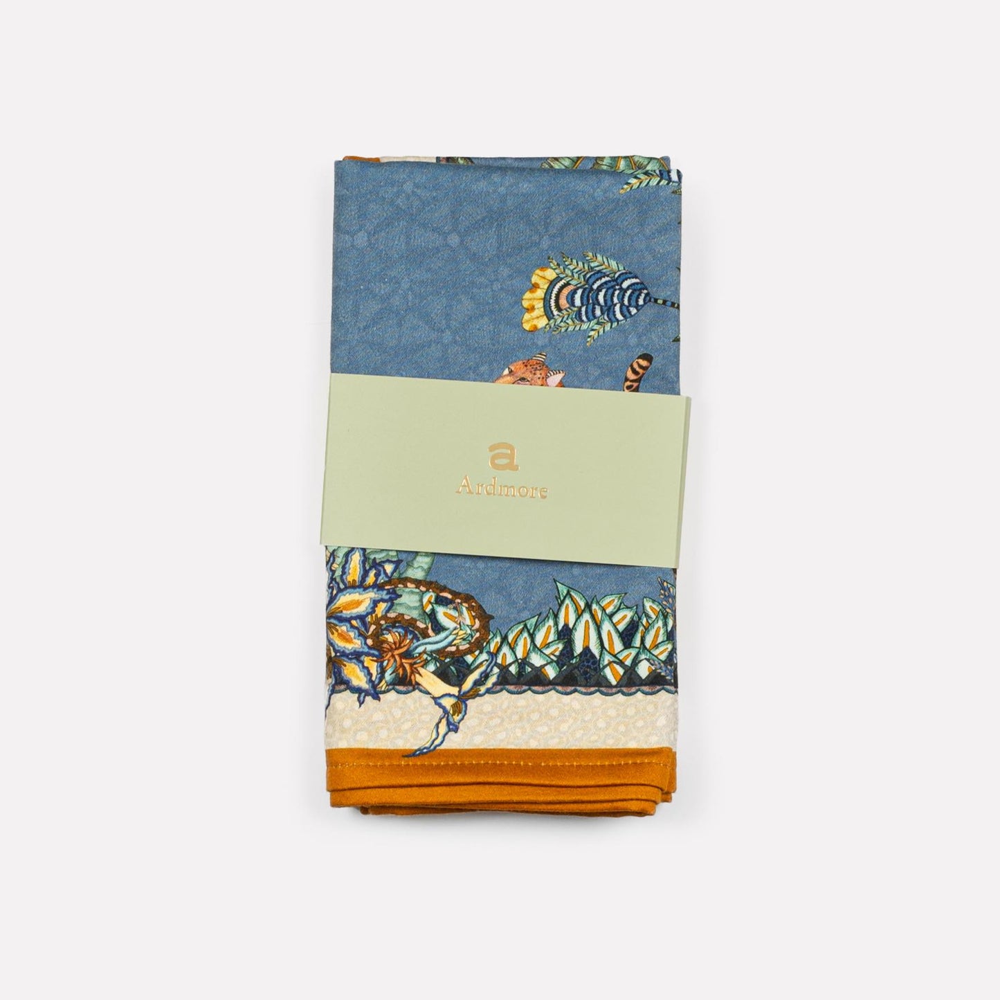 Close-up of the Ardmore Design Sabie Forest napkin in Tanzanite, highlighting the fine satin weave cotton and vibrant hand-drawn patterns.