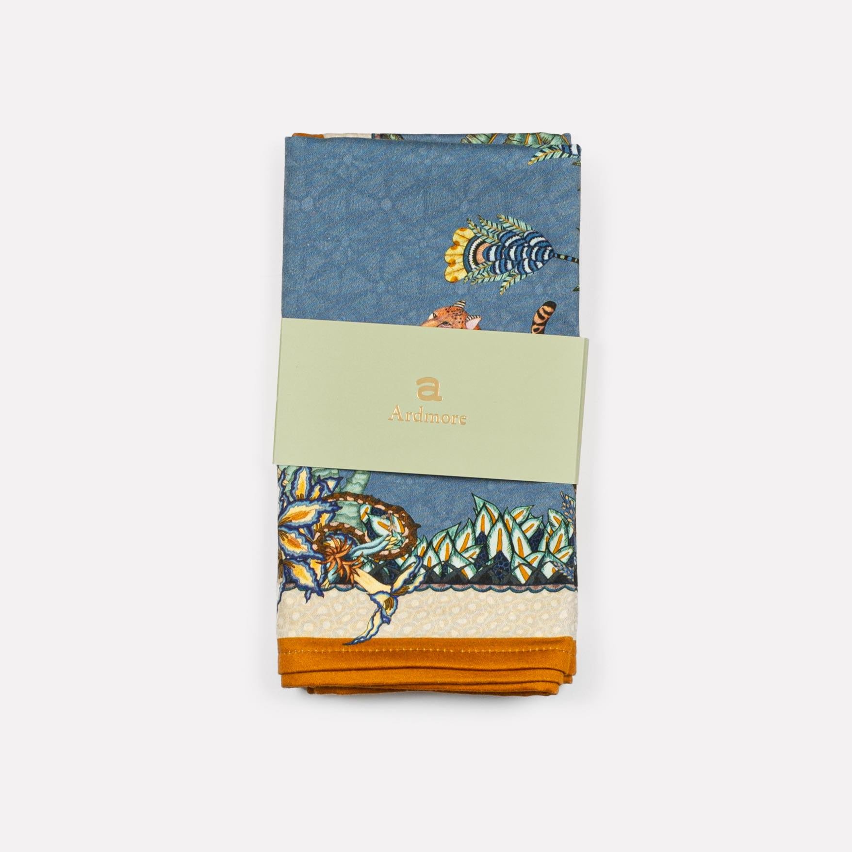 Close-up of the Ardmore Design Sabie Forest napkin in Tanzanite, highlighting the fine satin weave cotton and vibrant hand-drawn patterns.