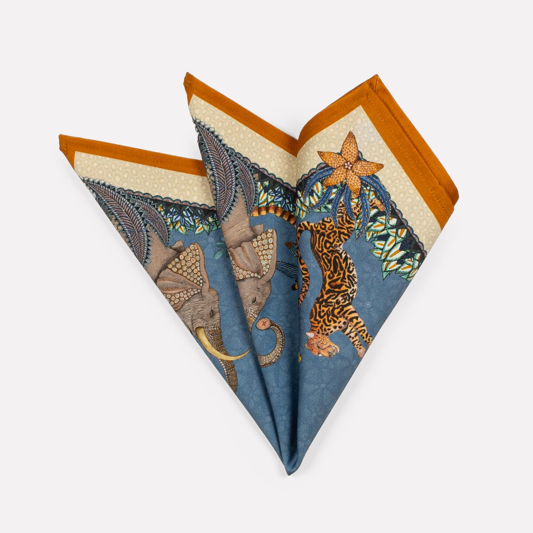 A set of three neatly folded Sabie Forest napkins in Tanzanite, featuring intricate African-inspired patterns with rich blue and gold hues.
