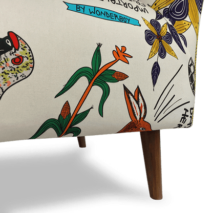 A macro shot of the wooden legs and fabric texture, emphasising the craftsmanship of the upholstery and the detailed artistic prints that make each chair unique.