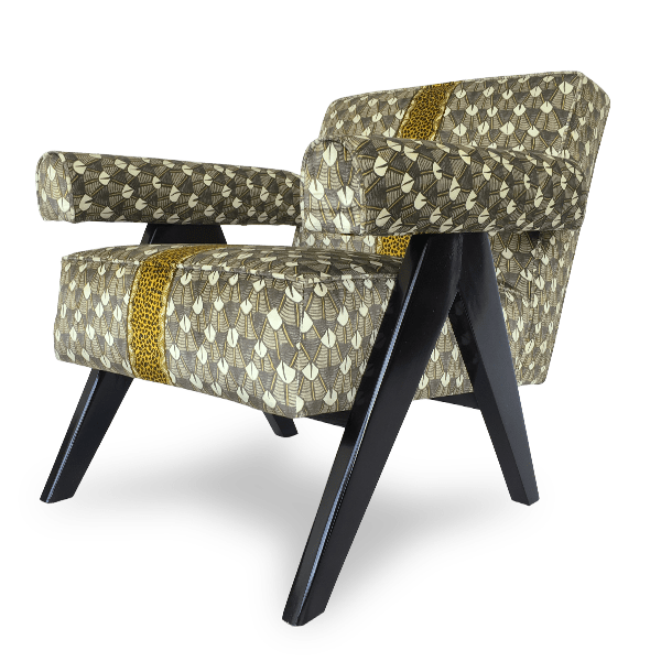  A three-quarter angle shot of the chair, displaying its plush cushioning, curved armrests, and sleek black wooden legs.