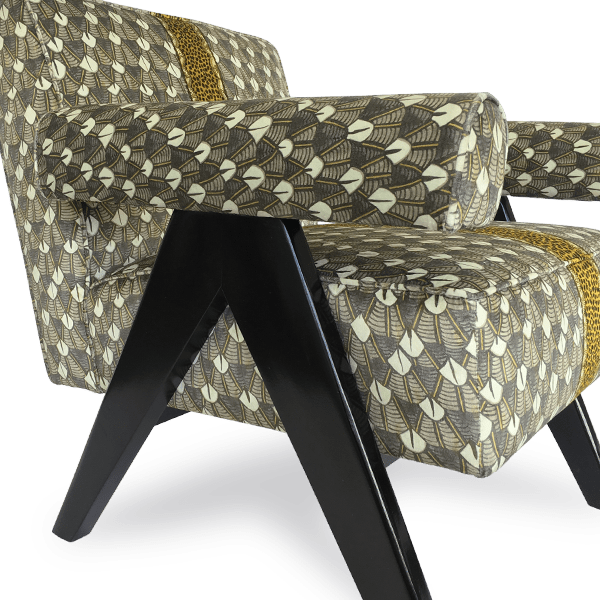 A profile shot of the chair, highlighting its deep seat, sturdy structure, and luxurious fabric texture.