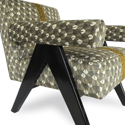 A profile shot of the chair, highlighting its deep seat, sturdy structure, and luxurious fabric texture.