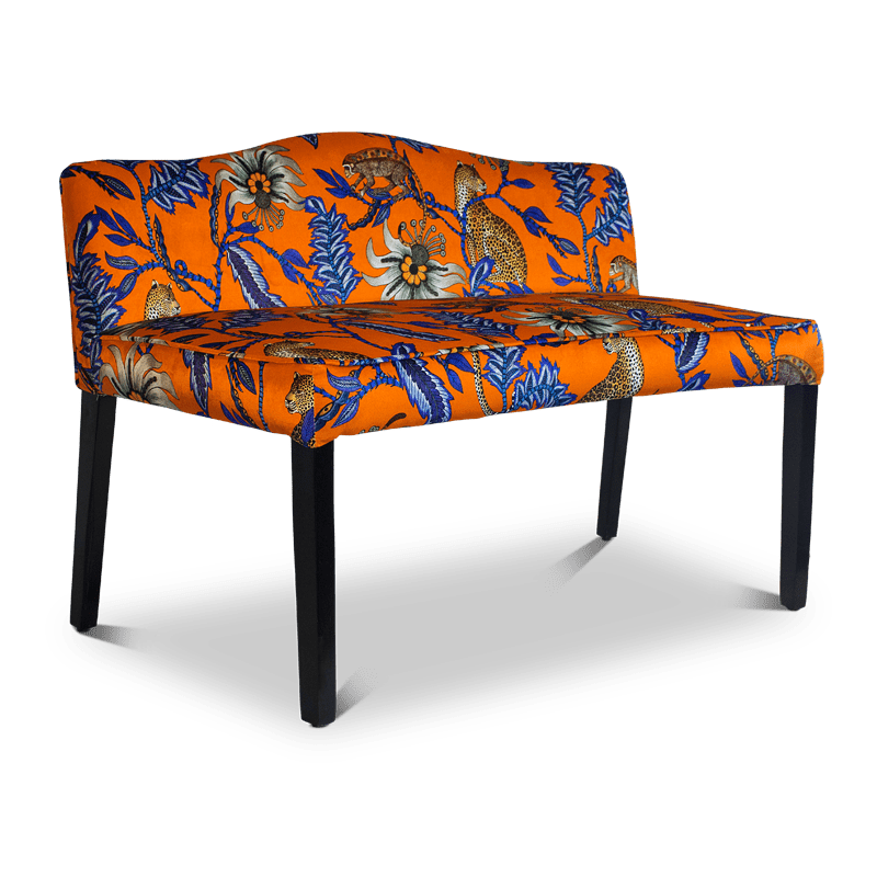 A three-quarter angle shot showcasing the depth of the bench, highlighting its structured black legs, plush cushioning, and dynamic upholstery design.