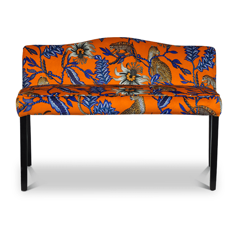 A straight-on shot of the Zambezi Monkey Bean Flame Bench, upholstered in a striking orange and blue velvet fabric, featuring intricate African-inspired patterns and a modern silhouette.