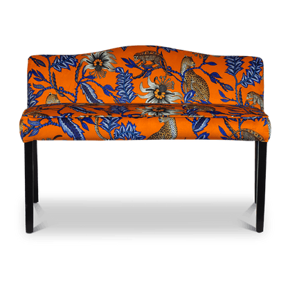 A straight-on shot of the Zambezi Monkey Bean Flame Bench, upholstered in a striking orange and blue velvet fabric, featuring intricate African-inspired patterns and a modern silhouette.