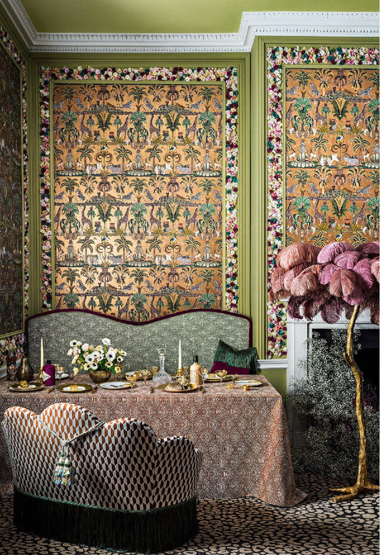A luxurious dining space adorned with Afrika Kingdom wallpaper, showcasing mirrored African wildlife amidst lush greenery.