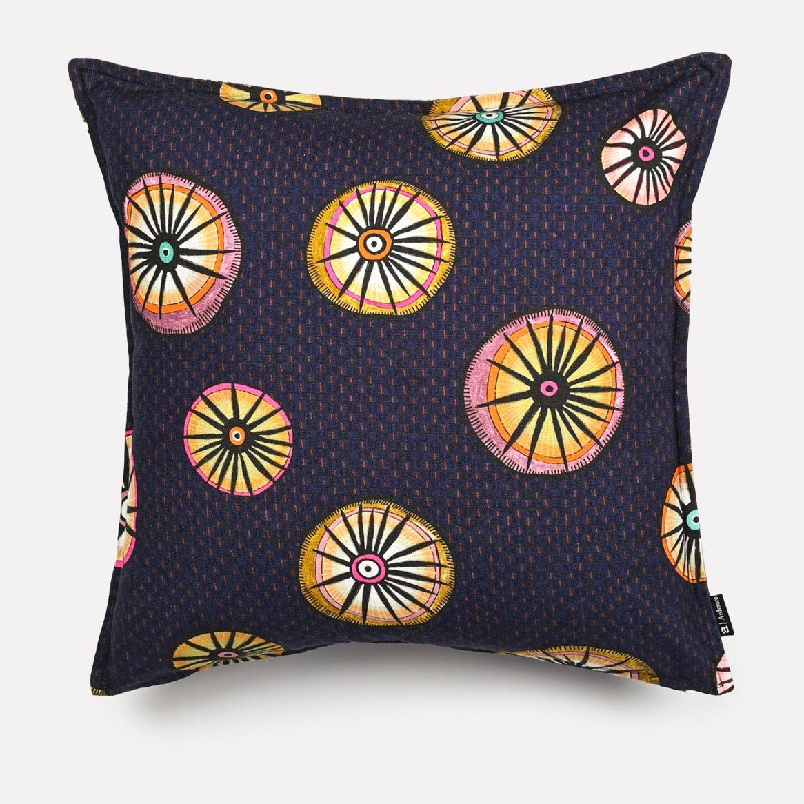A 50x50cm rectangular cushion cover in Amasumpa Moonlight fabric, featuring a dark navy base with circular geometric patterns in gold, orange, and pink.