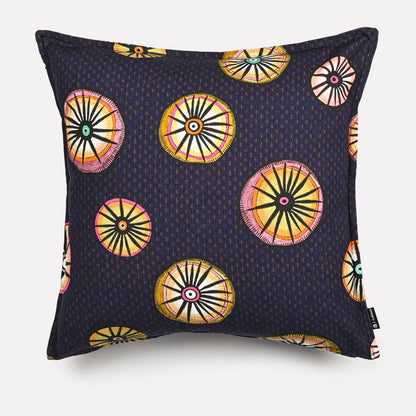 A 50x50cm rectangular cushion cover in Amasumpa Moonlight fabric, featuring a dark navy base with circular geometric patterns in gold, orange, and pink.