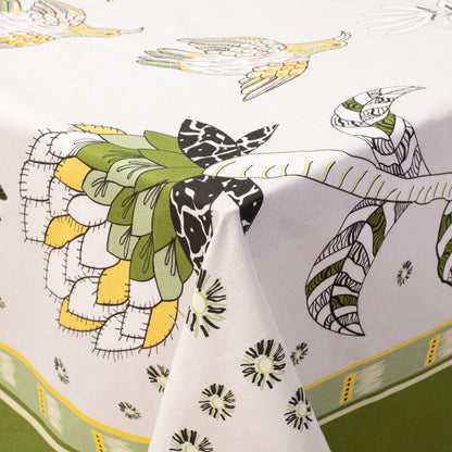 The Bird Fynbos Tablecloth in Savannah draped over a table, showcasing its intricate floral and bird motifs.
