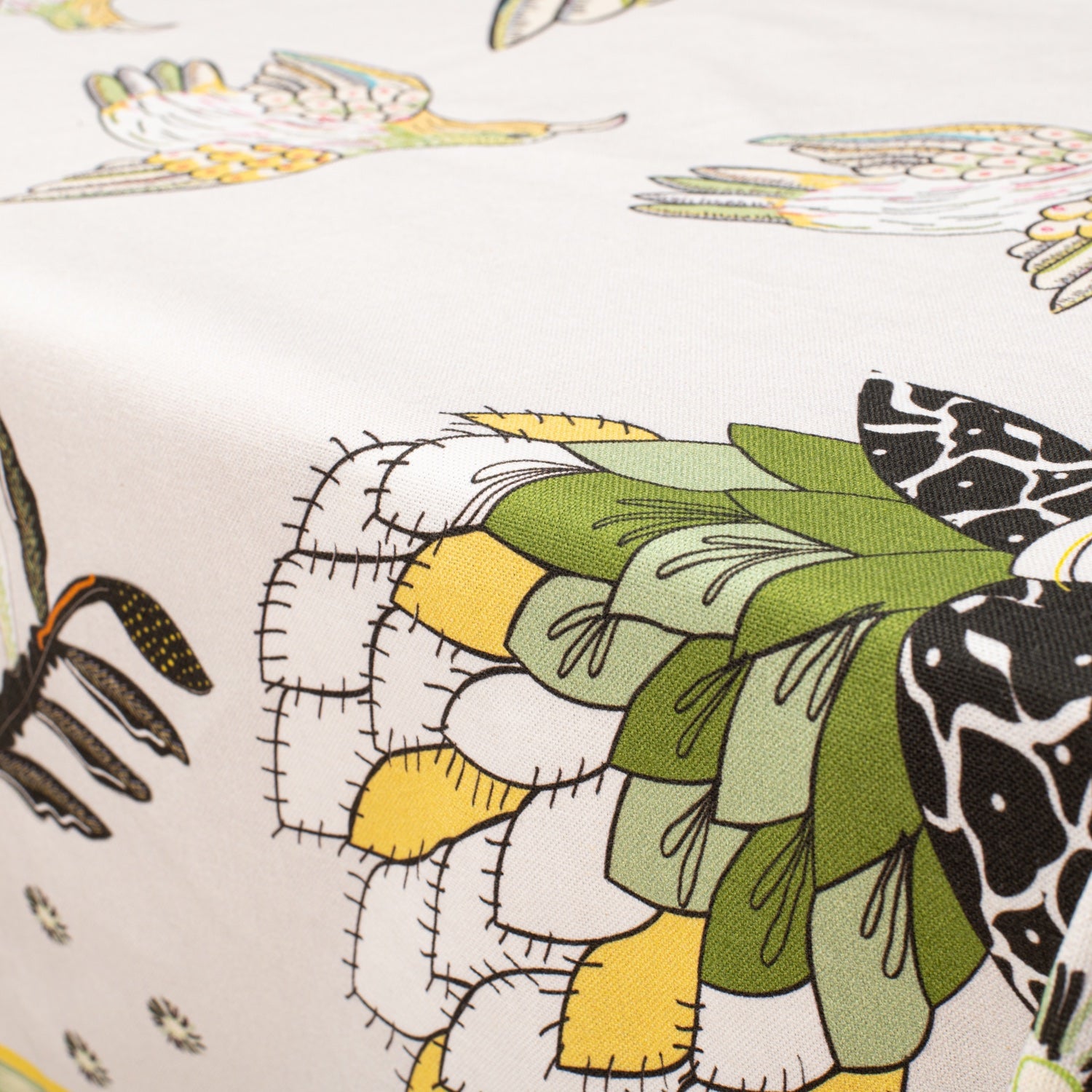 A close-up showcasing the intricate bird and fynbos design, bringing out the natural theme of the tablecloth.