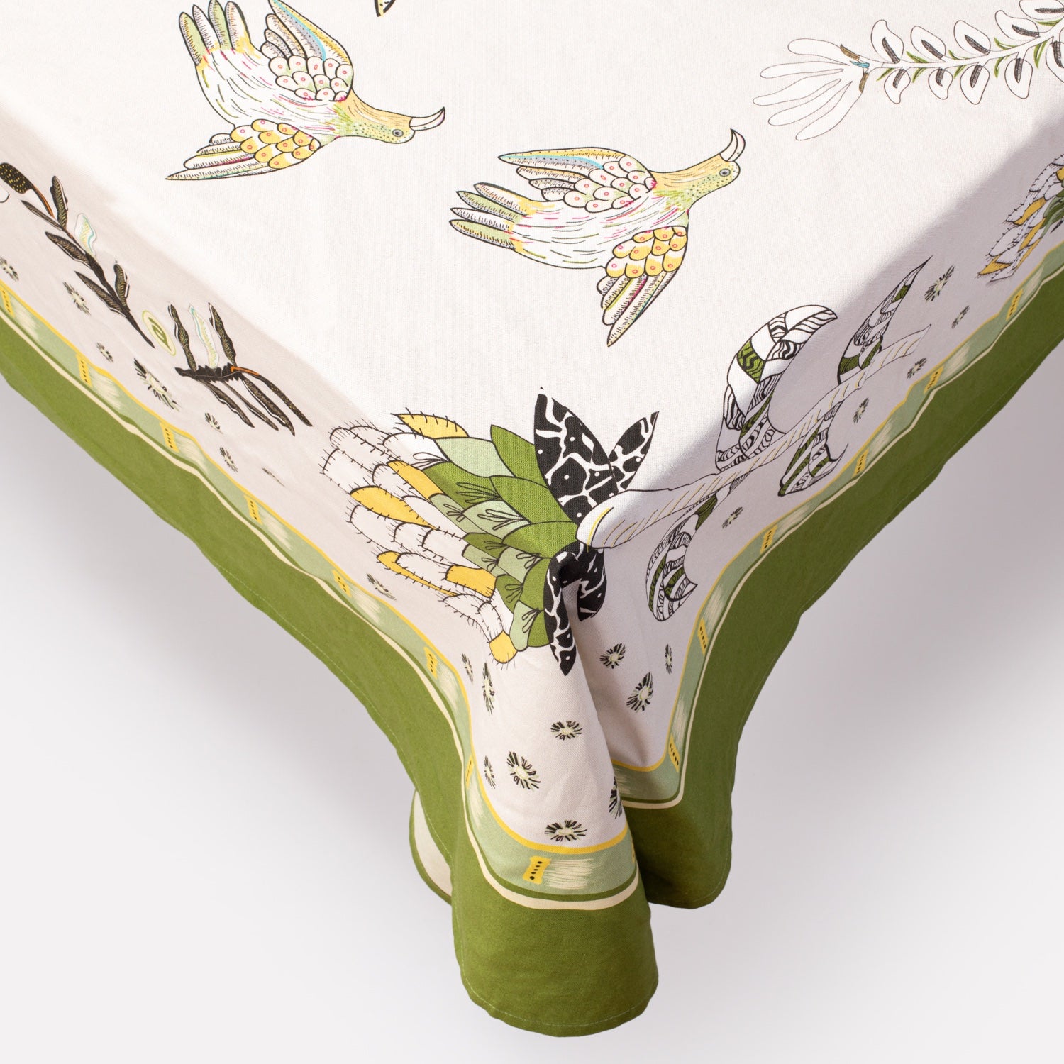 A detailed macro shot of the tablecloth's corner, highlighting the elegant green trim and fabric texture.
