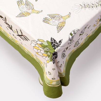 A detailed macro shot of the tablecloth's corner, highlighting the elegant green trim and fabric texture.