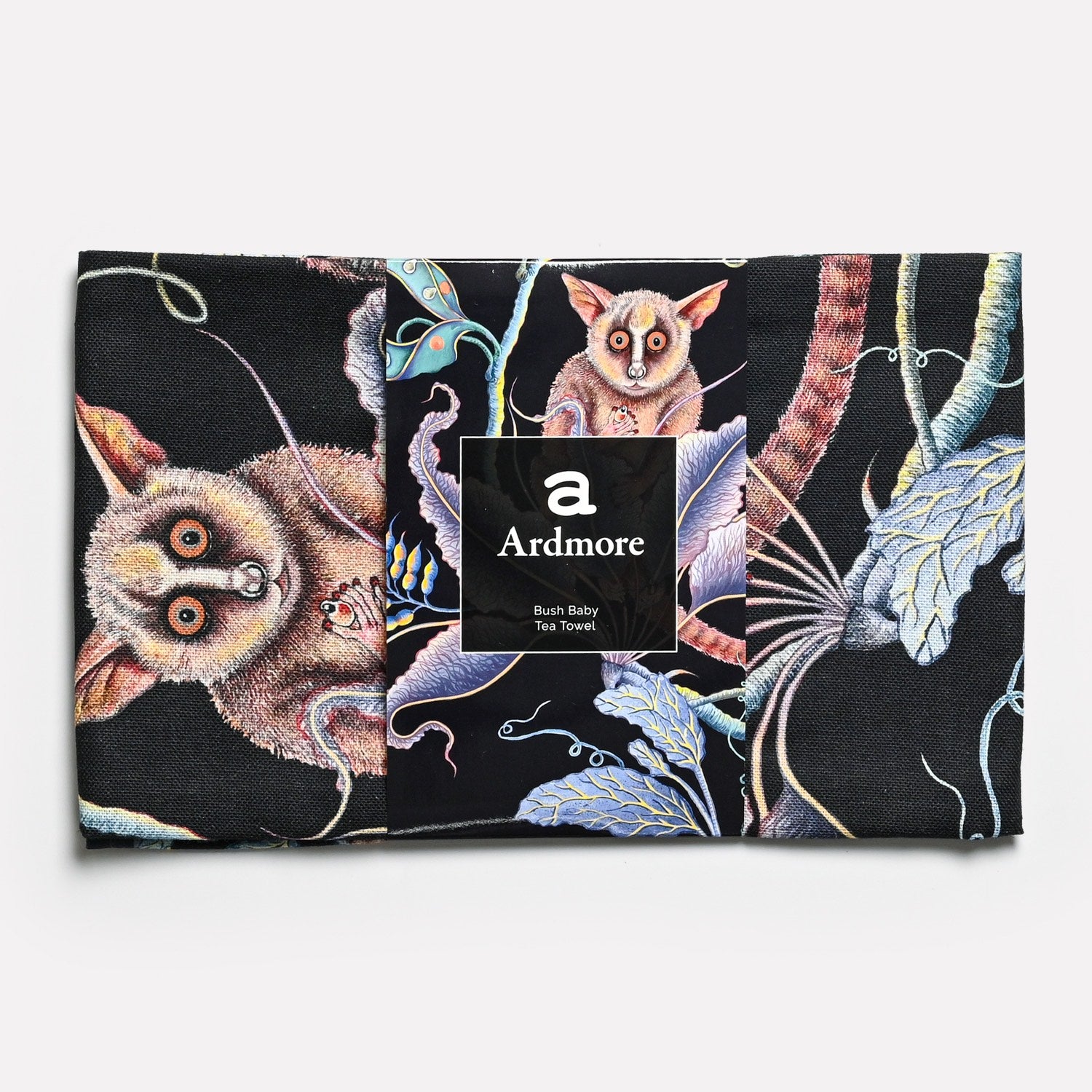 The tea towel in its original packaging, highlighting its refined design and African-inspired artistry.