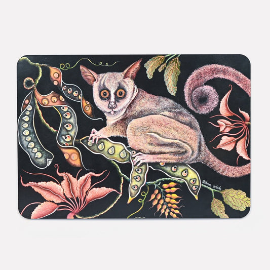 A hardboard placemat featuring a detailed illustration of a bush baby with large, glowing eyes, surrounded by lush foliage and exotic flowers against a dark background.