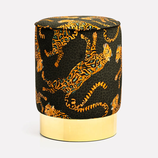 Elegant Ardmore Cheetah Kings Amber Velvet Pouffe, featuring a luxurious black velvet fabric adorned with vibrant amber cheetah motifs, set atop a polished brass base.