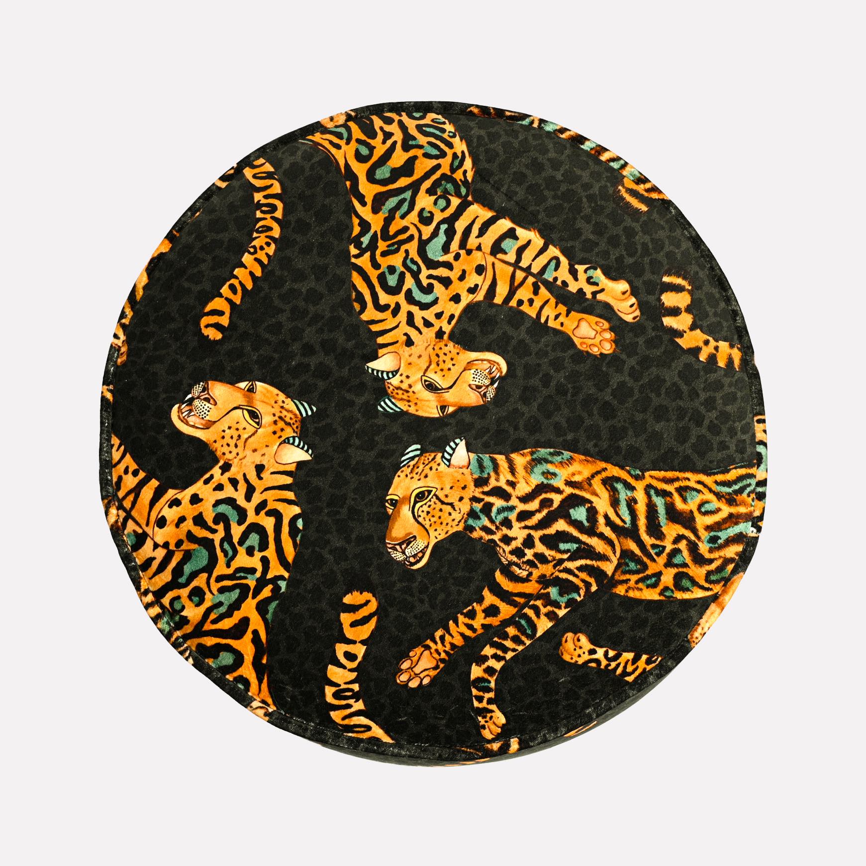Top-down view of the Ardmore Cheetah Kings Amber Velvet Pouffe, emphasizing the intricate design of the cheetah motifs against the deep amber and black tones.