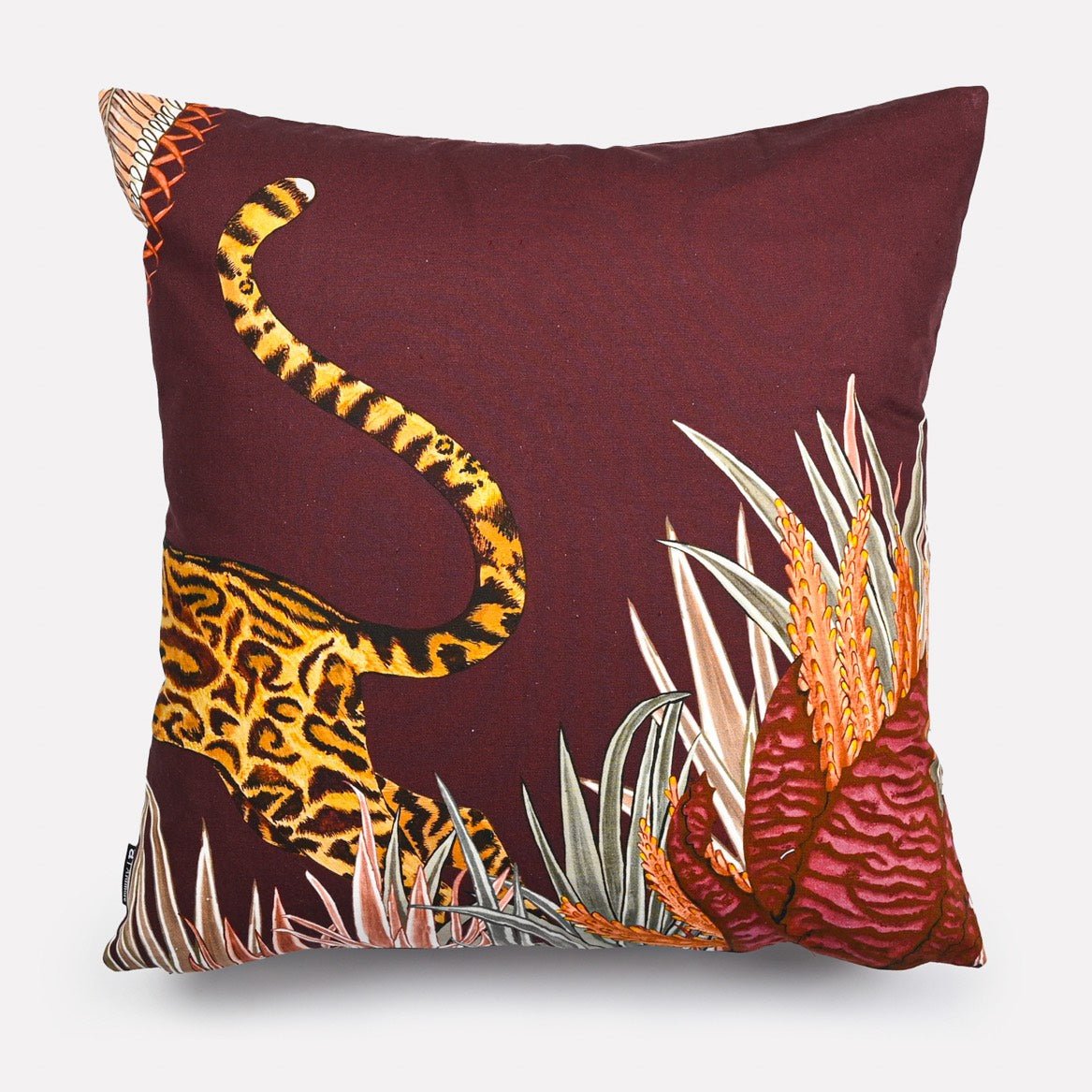 Back view of the Cheetah Kings Forest Plum Cotton cushion cover in a solid plum tone with a cheetah's tail adding a whimsical detail.