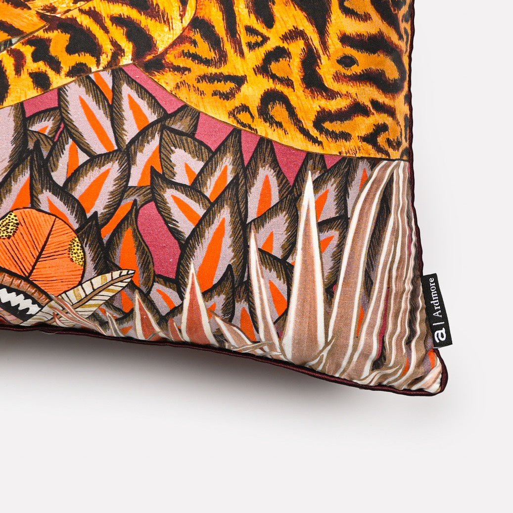 Close-up of the Cheetah Kings Forest Plum Silk cushion cover highlighting the detailed craftsmanship of the cheetah and foliage pattern with rich colours and textures.