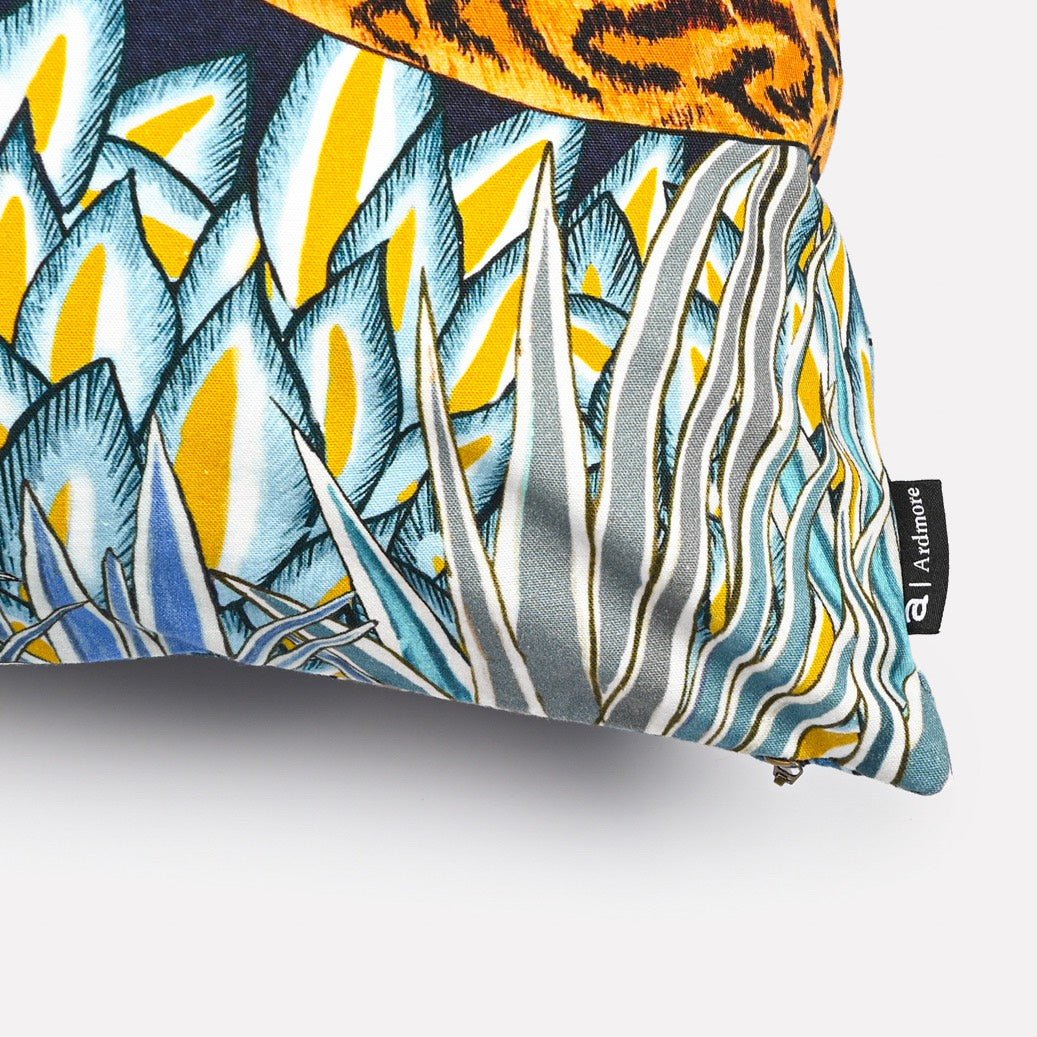 Close-up of the Cheetah Kings Forest Tanzanite Cotton cushion cover highlighting the intricate tanzanite-inspired cheetah and detailed tropical leaf patterns.