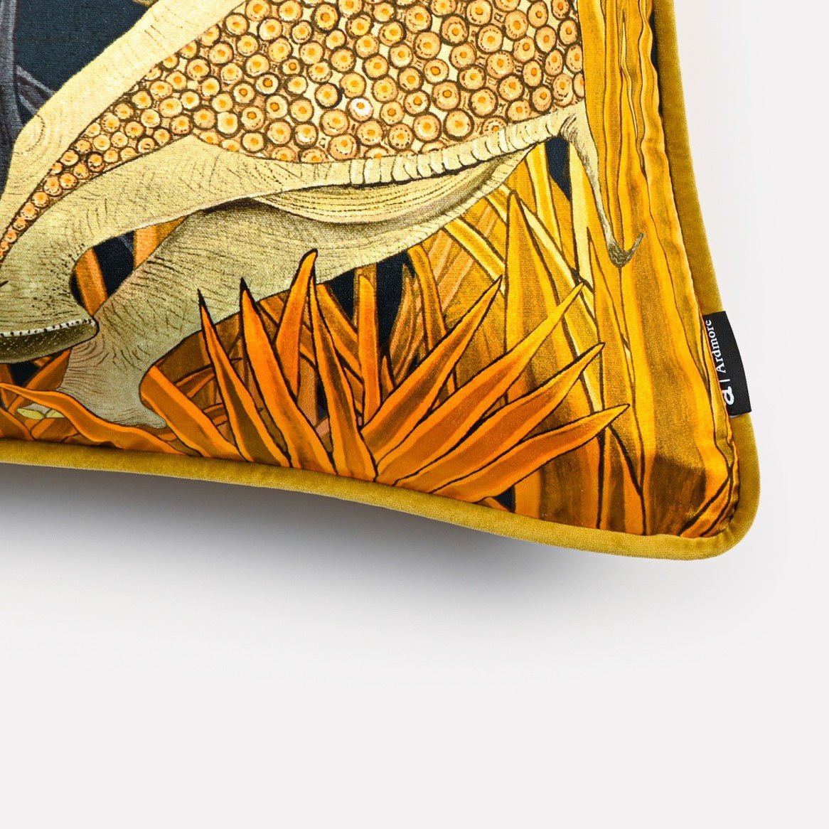 Angled close-up of the Dancing Elephant Moonlight cushion cover, highlighting the textured patterns of the elephants and the vibrant gold accents on the black velvet fabric.