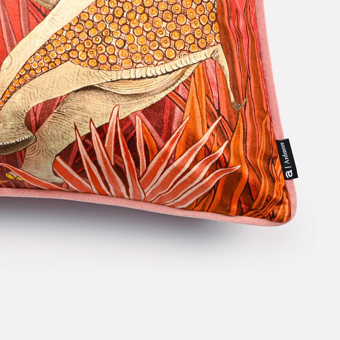 Angled close-up of the Dancing Elephant Sunset cushion cover, highlighting the intricate patterns of the elephants and the rich hues of the sunset-themed velvet fabric.