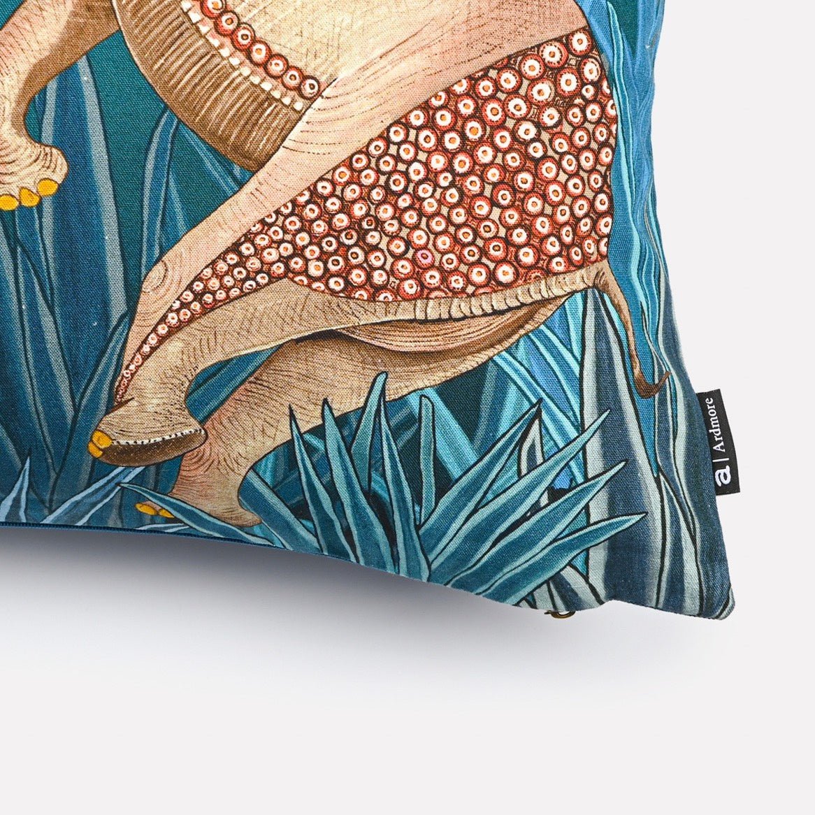 Angled view of the Dancing Elephant Teal Lake cushion cover, highlighting the textured design of the elephants and detailed stitching on the teal background.