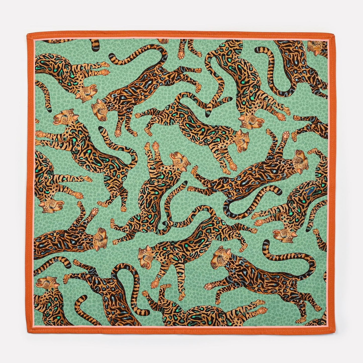 A full view of the Ardmore Cheetah King napkin in Jade, featuring an intricate design of roaming cheetahs against a jade green background, accented with turquoise and gold tones.