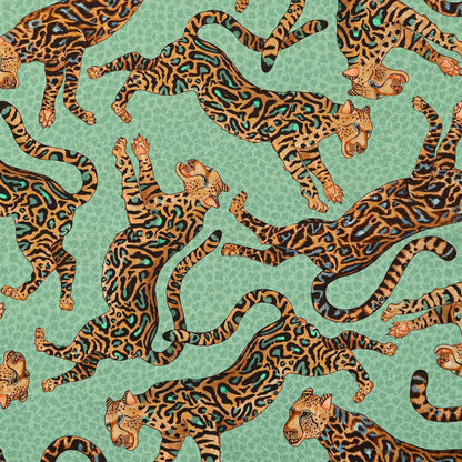 A detailed close-up of the Ardmore Cheetah King napkin print, highlighting the striking cheetah motifs and the luxurious jade and gold colour palette.