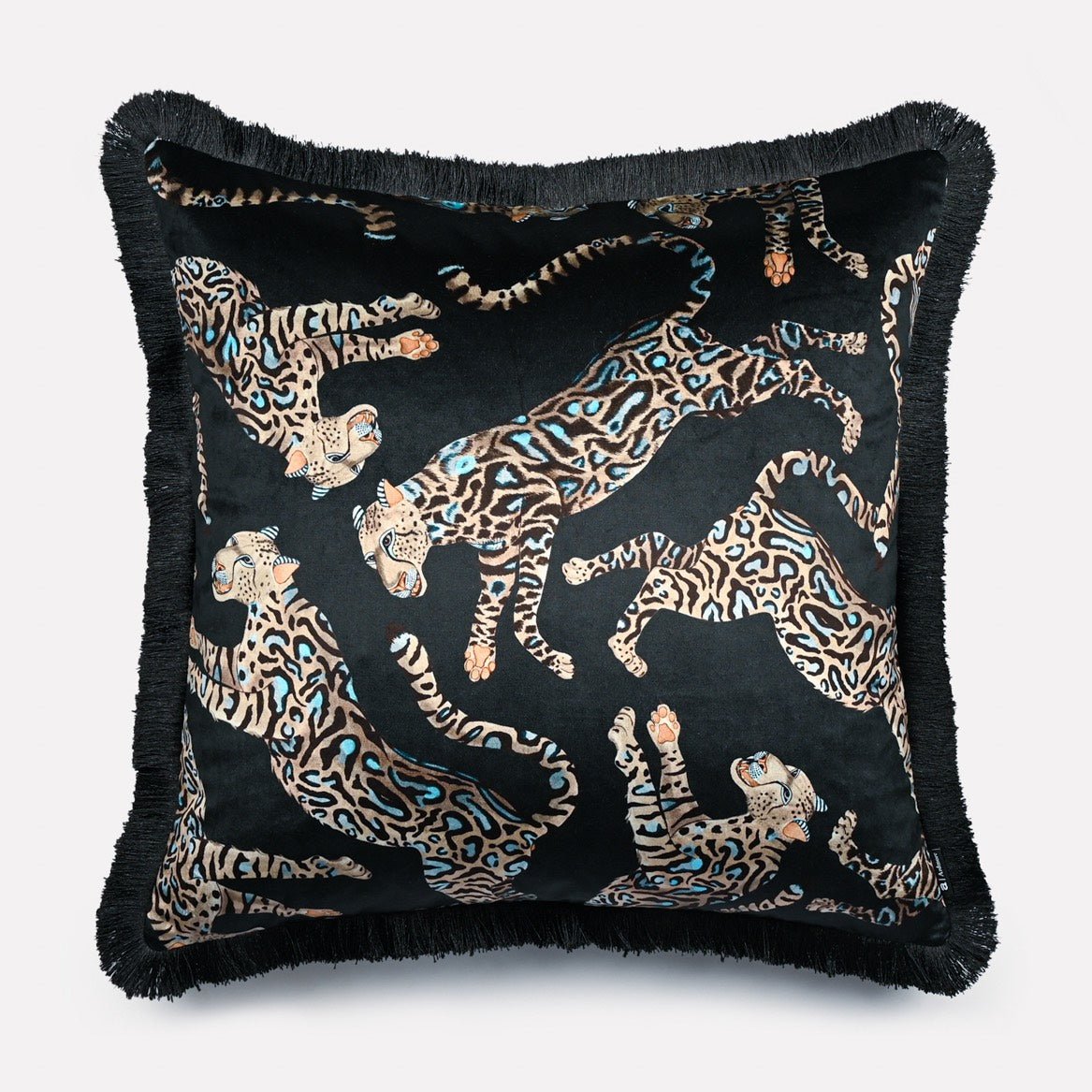 Angled view of the Cheetah Kings Starry Nights velvet cushion cover with fringe, highlighting the intricate cheetah motifs and the rich texture of the velvet fabric.