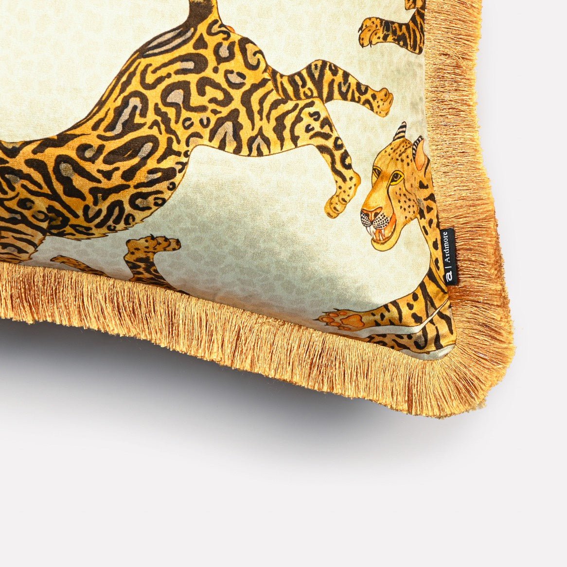 Close-up of the Cheetah Kings Stone velvet cushion cover, showcasing the refined texture of the velvet fabric, detailed cheetah pattern, and golden fringe accents.