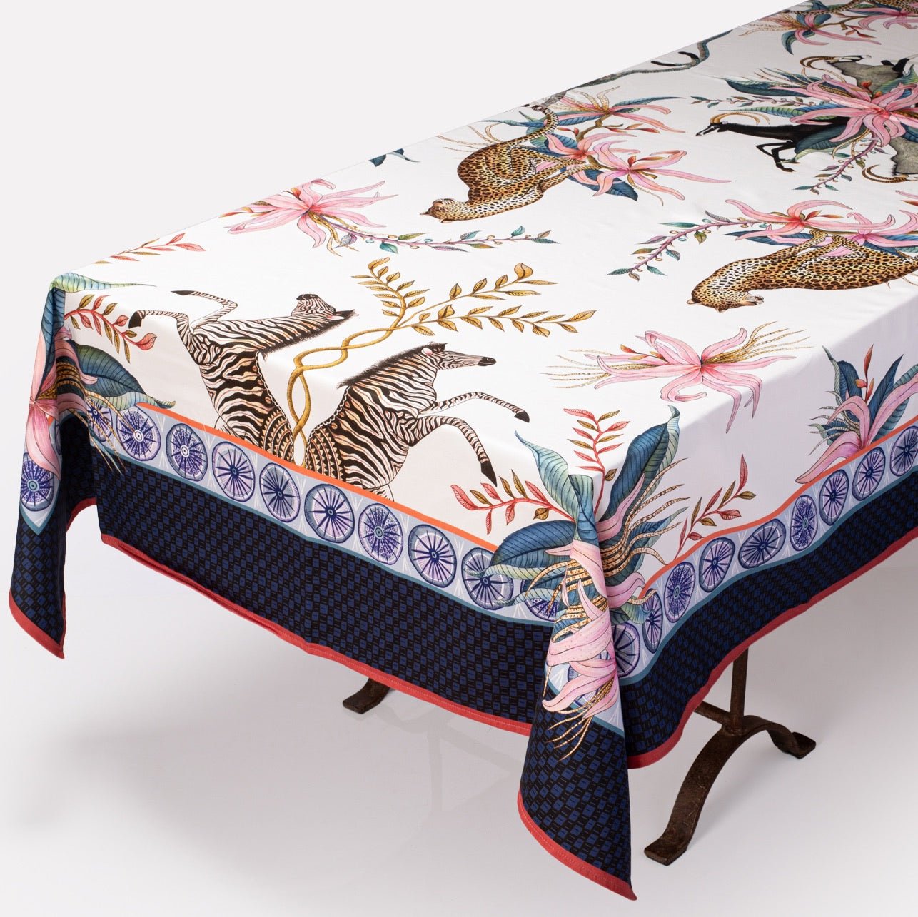 A three-quarter view of the tablecloth, showing the luxurious draping and rich safari-inspired patterns.