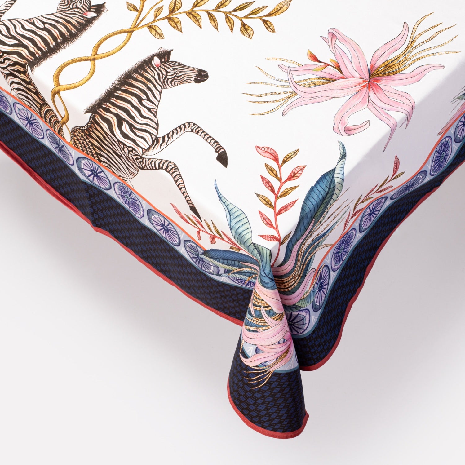  A detailed close-up highlighting the fine illustration of a zebra, surrounded by intricate florals along the fabric border.