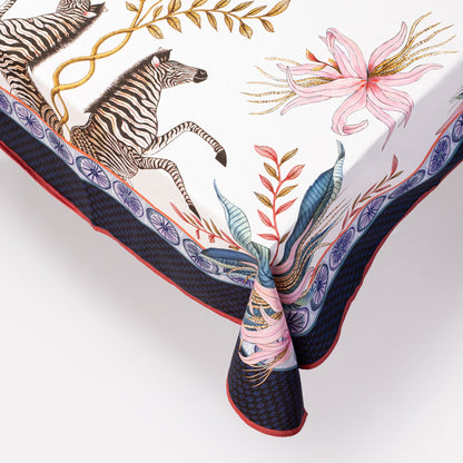  A detailed close-up highlighting the fine illustration of a zebra, surrounded by intricate florals along the fabric border.