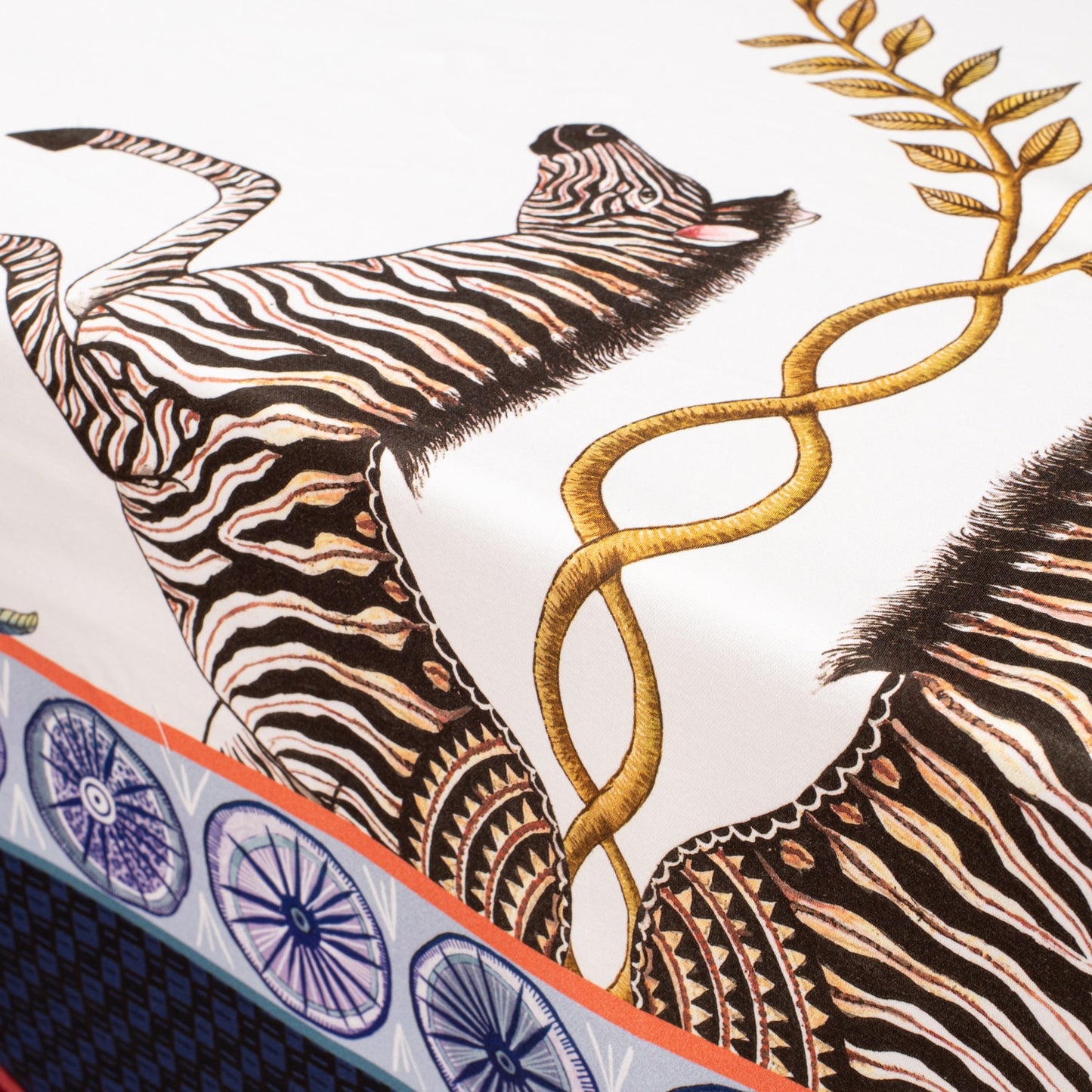 A macro shot showcasing the beautiful flow of the fabric, featuring a mix of wildlife and botanical elements.