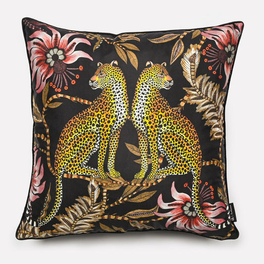 Cushion cover in Lovebird Leopards Night design, featuring a bold print with two leopards surrounded by intricate floral patterns on a dark black background.